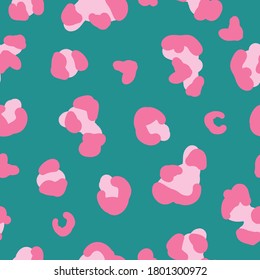 Seamless trend pattern. Bright pink spots of a leopard on a turquoise background. Fashionable print is suitable for textiles.