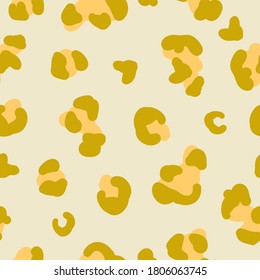 Seamless trend pattern. Mustard spots of a leopard on a light background. The print is suitable for textiles .