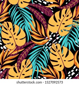 Seamless tropical pattern with beautiful yellow and blue leaves and plants on dark background. Beautiful print with hand drawn exotic plants. Colorful stylish floral.