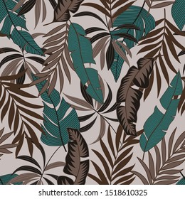Seamless tropical pattern with bright exotic leaves and plants in light colors on a beige background. Summer colorful hawaiian seamless pattern with tropical plants. Tropic leaves in bright colors.