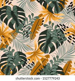 Seamless tropical pattern with bright green and orange leaves and plants on beige background. 
Jungle leaf seamless vector floral pattern background. Tropic leaves in bright colors.