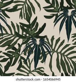 Seamless tropical pattern with dark colorful leaves and plants. Seamless exotic pattern with tropical plants. Exotic wallpaper. Trendy summer Hawaii print.