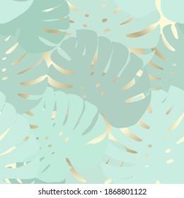 Seamless tropical pattern with delicate large leaves on a gold background. Modern abstract design for fabric, paper, interior decor. Colorful ornament trendy color blue, green, birch, aquamarine