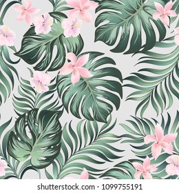 Seamless tropical pattern with jungle flowers and palm leaves. Summer print.