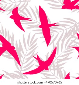 Seamless tropical pattern with silhouettes of birds and palm sheets. Vector summer background