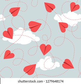 Seamless Valentines Day pattern of heart shaped paper airplanes. Flying red hearts on blue sky background. Vector Illustration