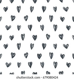 Seamless vector background with black hearts on a white background. Hand drawn.