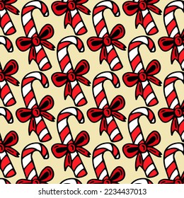 Seamless vector background with candy. Christmas pattern with candy canes. Vector background for printing, winter holidays, greeting cards, fabric, textiles, wrapping paper.