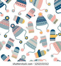 Seamless vector background with hats and mittens. Pattern tile with knitted winter clothes in pink and blue. Winter wear design, flat Scandinavian style. Use for paper, banner, cards, poster, fabric.