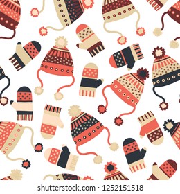 Seamless vector background with hats and mittens. Pattern tile with knitted winter clothes in red and blue. Winter wear design, flat Scandinavian style. Use for paper, banner, cards, poster, fabric.