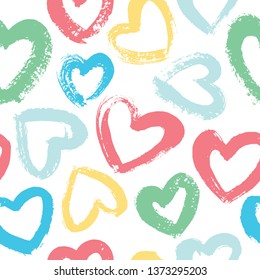 Seamless vector background with hearts in pastel colors. Drawn with a dry brush.