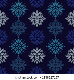 Seamless vector background with Norwegian snowflakes. Pixel snowflakes. Winter pattern. Textile rapport.
