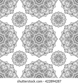 Seamless vector background. The pattern with contour filigree mandalas. Oriental floral ornament. Template for textiles.