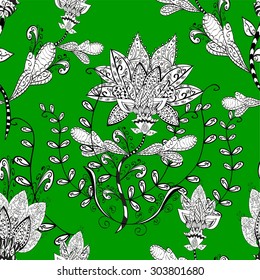Seamless vector background pattern of hand drawn black and white abstract ethnic doodle flowers on green background.