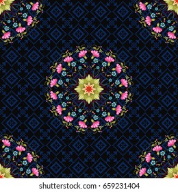 Seamless vector background. Round floral Ukrainian ornament in the style of Petrykivka painting. Dark backdrop with pattern similar to cross stitch.