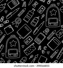 Seamless vector background with school supplies, white chalk on black board