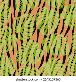 Seamless vector background of tropical leaves and animal fur. Ornament for textile, fabric, wallpaper, surface design.