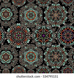 Seamless vector background. Winter Holiday Knitted Pattern with violet, orange and pink Circles, Dots and Snowflakes On a Black Background.