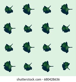 Seamless vector boho hipster pattern with Gingko Biloba leaves on a mint green background. Floral summer pattern for notebooks or children's fashion. Retro vintage trendy exotic endless background.