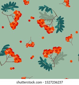 Seamless vector bright illustration with rowan berries on a green background. For decorating textiles, packaging.