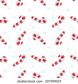 Seamless vector Christmas texture. Seamless backdrop with  candy canes and snowflakes.  Simple style pattern background with traditional Christmas holiday symbols. Wrapping paper texture.