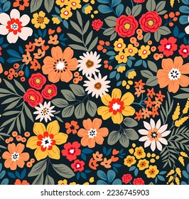 Seamless vector floral pattern. Liberty background of bright colorful abstract flowers. Print with bouquets of flowers from the garden. Bright yellow and red flowers on a dark blue background.