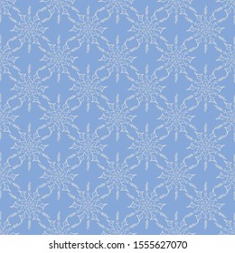 Seamless vector in geometric ornamental style. White 
snowflakes on a blue background.
