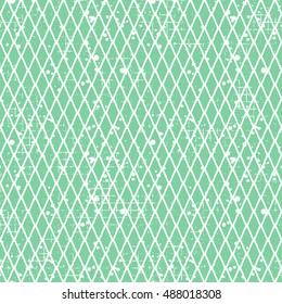 Seamless vector grunge pattern. Creative geometric green background with rhombus. Grunge texture with attrition, cracks and ambrosia. Old style vintage design. Graphic vector illustration.  