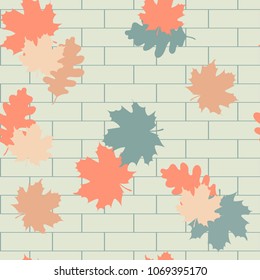 Seamless vector illustration with autumn leaves on brick wall background. For decorating textiles, packaging, wallpapers and web design.