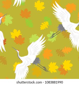 Seamless vector illustration with bird cranes and autumn leaves on a green background. For decorating textiles, packaging and web design.