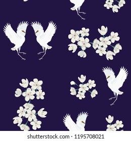 Seamless vector illustration with birds cranes and sakura on a dark background. For decorating textiles, packaging, covers, wallpapers.