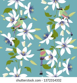 Seamless vector illustration with colors of clematis and birds. For decorating textiles, packaging and wallpaper.