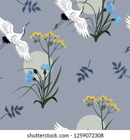 Seamless vector illustration with cornflowers, wild grasses and Japanese cranes. For decoration of textiles, packaging, wallpaper, web design.