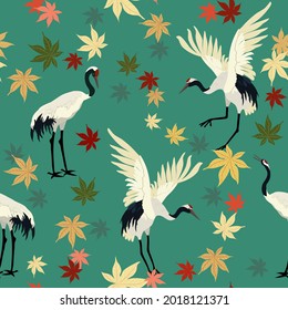 Seamless vector illustration with cranes and autumn maple leaves. For decorating textiles, packaging, wallpaper.