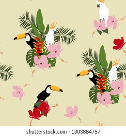 Seamless vector illustration with hibiscus flowers and a tropical birds. For decorating textiles, packaging, wallpaper.