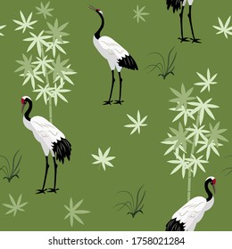 Seamless vector illustration with Japanese cranes and bamboo on a green background. For decorating textiles, packaging, wallpaper.