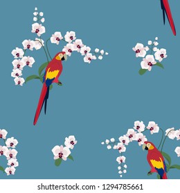 Seamless vector illustration with orchids and tropical beautiful parrots on blue background. For decorating textiles, packaging, web design.