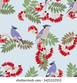 Seamless vector illustration with rowan berries and waxwing birds. For decoration of textiles, packaging, wallpaper.