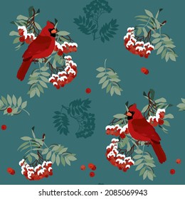 Seamless vector illustration with rowan branches, snowflakes, bird cardinal on a blue background. For decorating textiles, packaging for cosmetics, new year products.