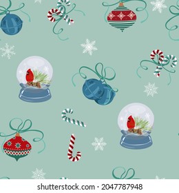 Seamless vector illustration. Snow globes, candy and christmas bells on blue background. For decorating textiles, packaging, postcards.