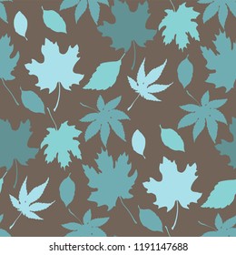 Seamless vector pattern with autumn leaves in silhouettes in cold colors