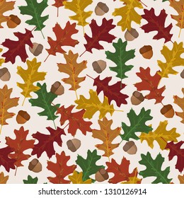 Seamless vector pattern with autumn leaves in seasonal colors. Oak leaf and acorn on white background