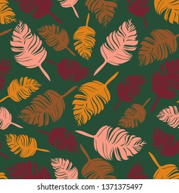 Seamless vector pattern with autumn leaves on green background. Beautiful colourful feathers wallpaper design. Abstract nature fashion textile.