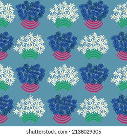 Seamless vector pattern with baskets of daisies and cornflowers on a blue background.