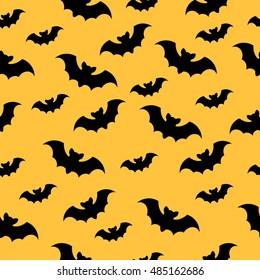 Seamless vector pattern with black bats on a yellow background. Halloween background. Night horror illustration.