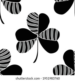 Seamless vector pattern with black clover leaf on white background. Good luck symbol wallpaper design. Decorative floral fashion textile.
