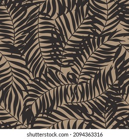 Seamless vector pattern with  black palm leafs on a beige background. Tropical ornament. Can be used as print on a fashion fabrics for clothes or home decor in tropical style.
