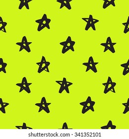 Seamless vector pattern of black stars on a light green background, painted by hand.