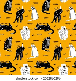 seamless vector pattern - black and white tigers on a yellow background. Celebrating new year and christmas. Hand drawn black and white striped tigers in festive caps. Social media wallpaper for 2022