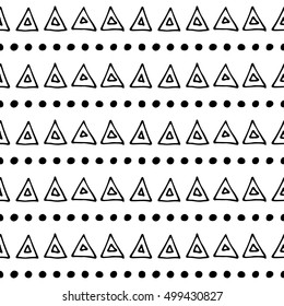 Seamless vector pattern. Black and white geometrical background with hand drawn little decorative elements, dots, triangles. Print with ethnic, folk, traditional motifs. Graphic vector illustration. 